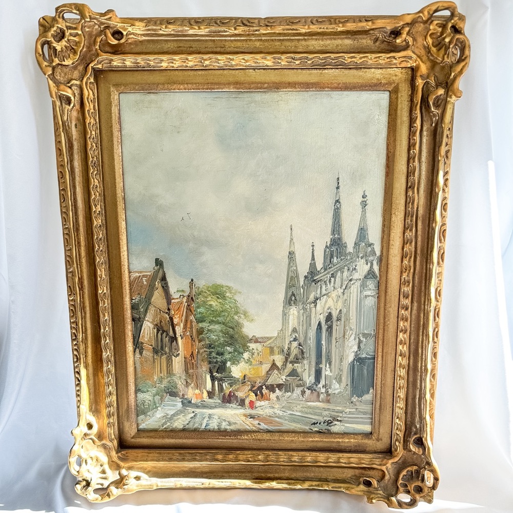 Antique framed Dutch town scene in ornate wooden frame
